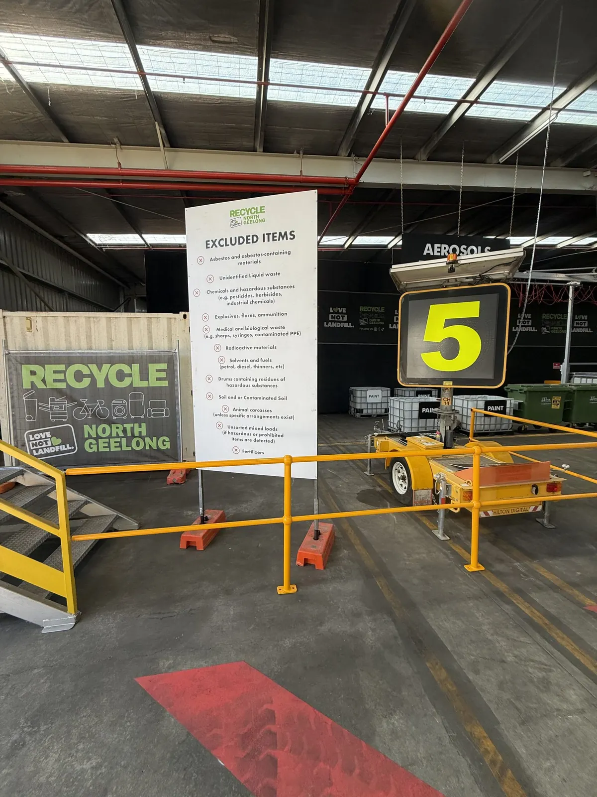 The excluded items board at the entry, next to a numbered bay sign